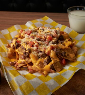 Create restaurant-quality nachos at home with seasoned ground beef and refried beans