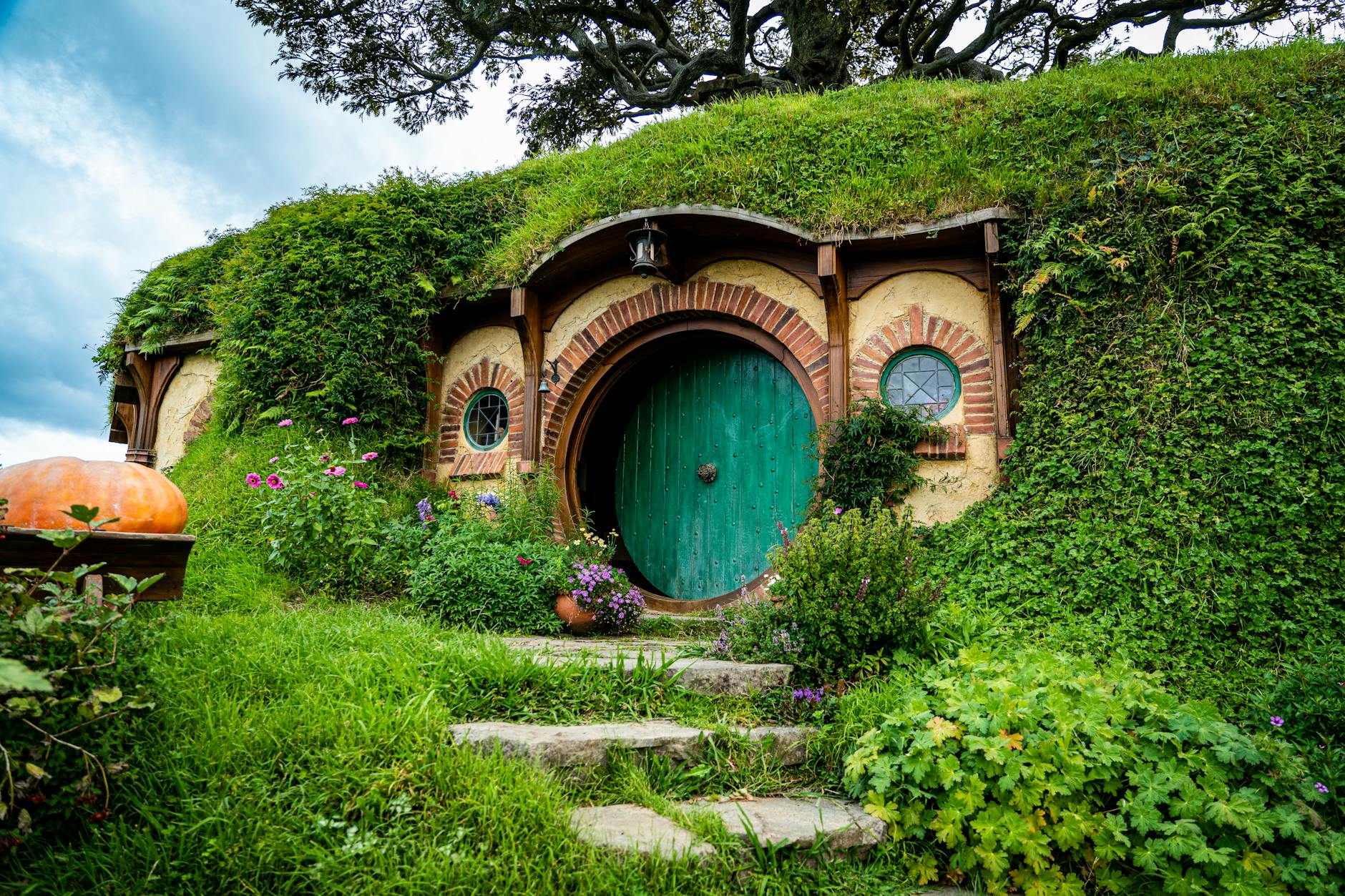 Lush moss carpets, hidden alcoves, and DIY accents showcase a backyard’s fairy-tale charm.